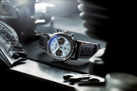 Breitling watch with dial, leather strap, tools.