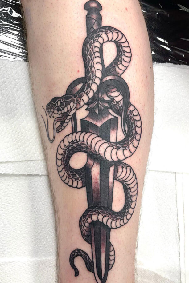 tribal snake and dagger tattoo