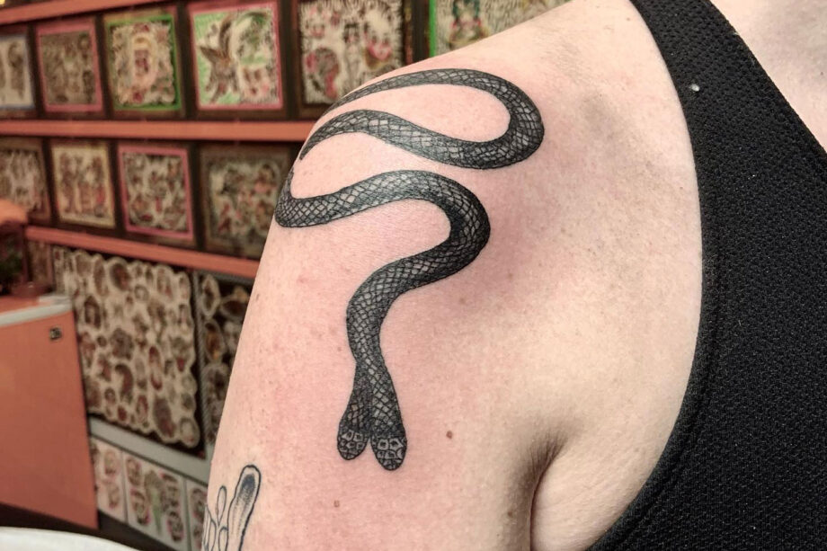 Fine line snake tattoo on hand