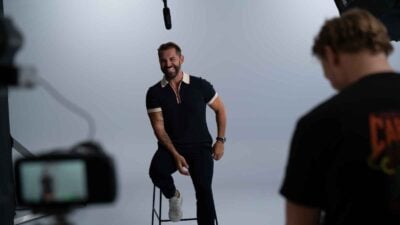 Daniel MacPherson poses in a photography studio.