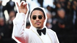 Salt Bae-like figure in restaurant attire gestures.
