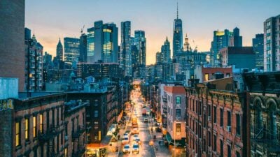 New York street at dusk with skyscrapers.