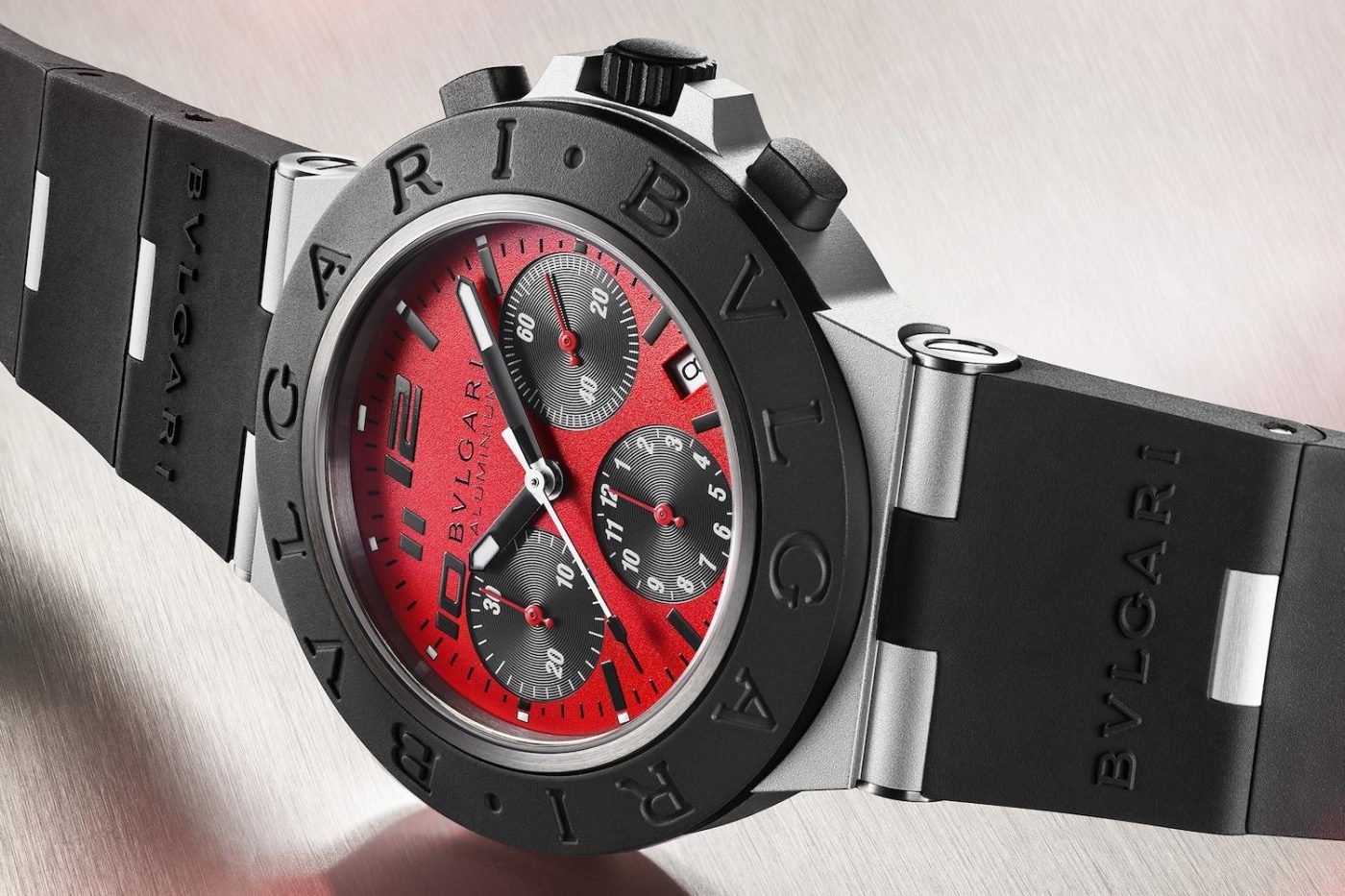 Bulgari watch: red dial, black rubber strap.