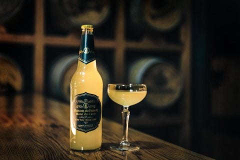 Maison De Brutes bottle exudes elegance, rustic setting.