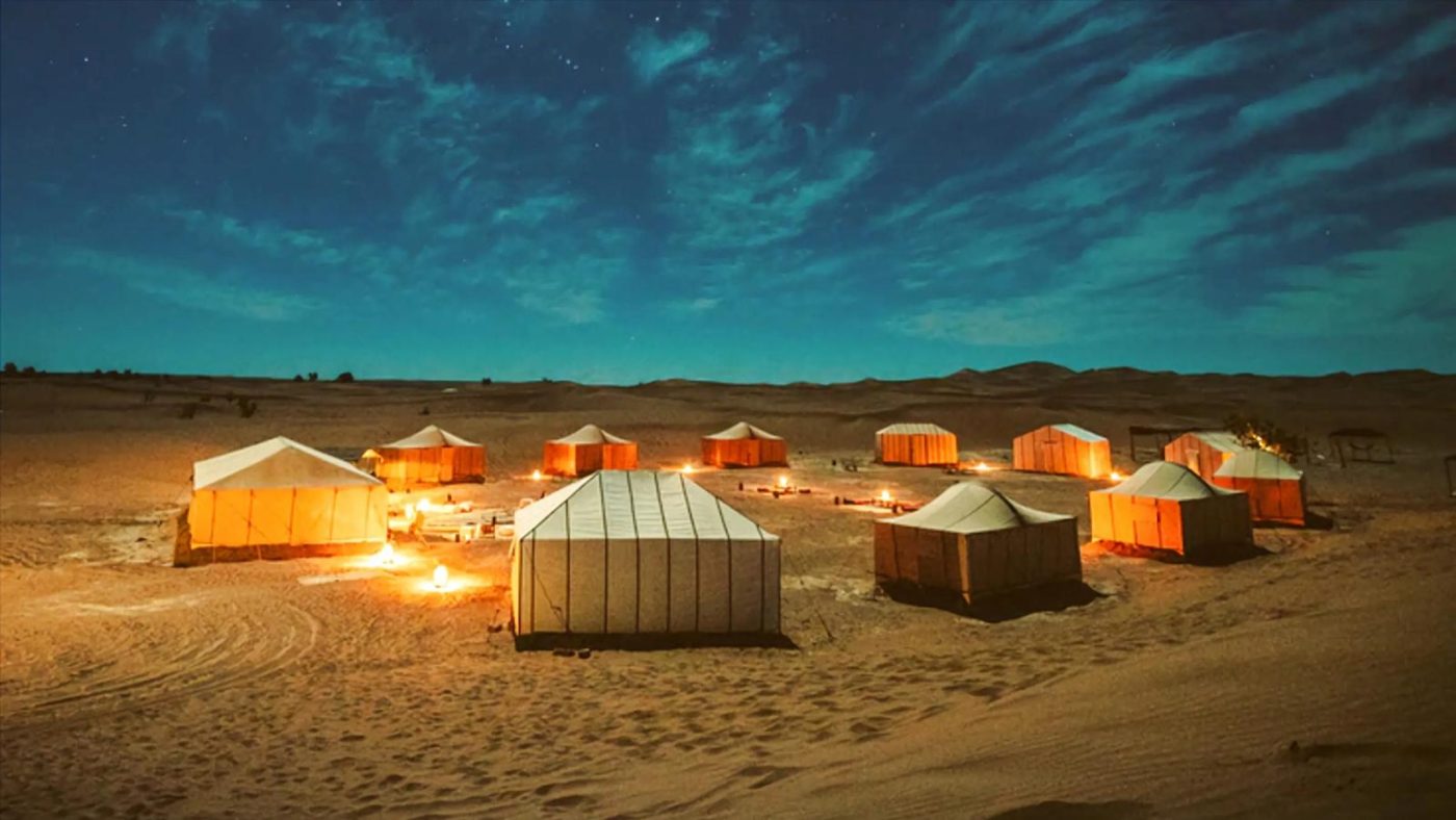 Desert tents in Qatar under serene night sky.