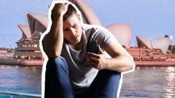 Man in gray t-shirt, phone, Sydney Opera House.