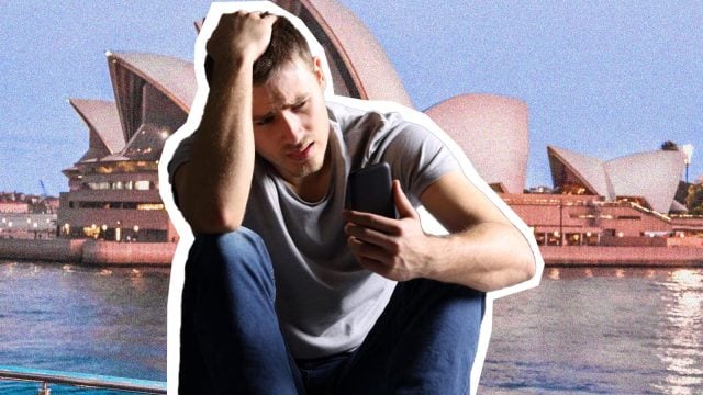 Man in gray t-shirt, phone, Sydney Opera House.