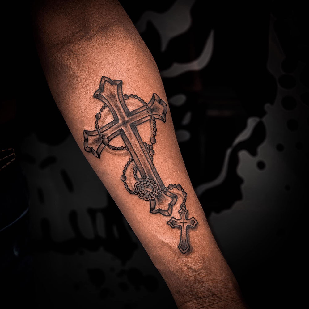 Under arm cross tattoo