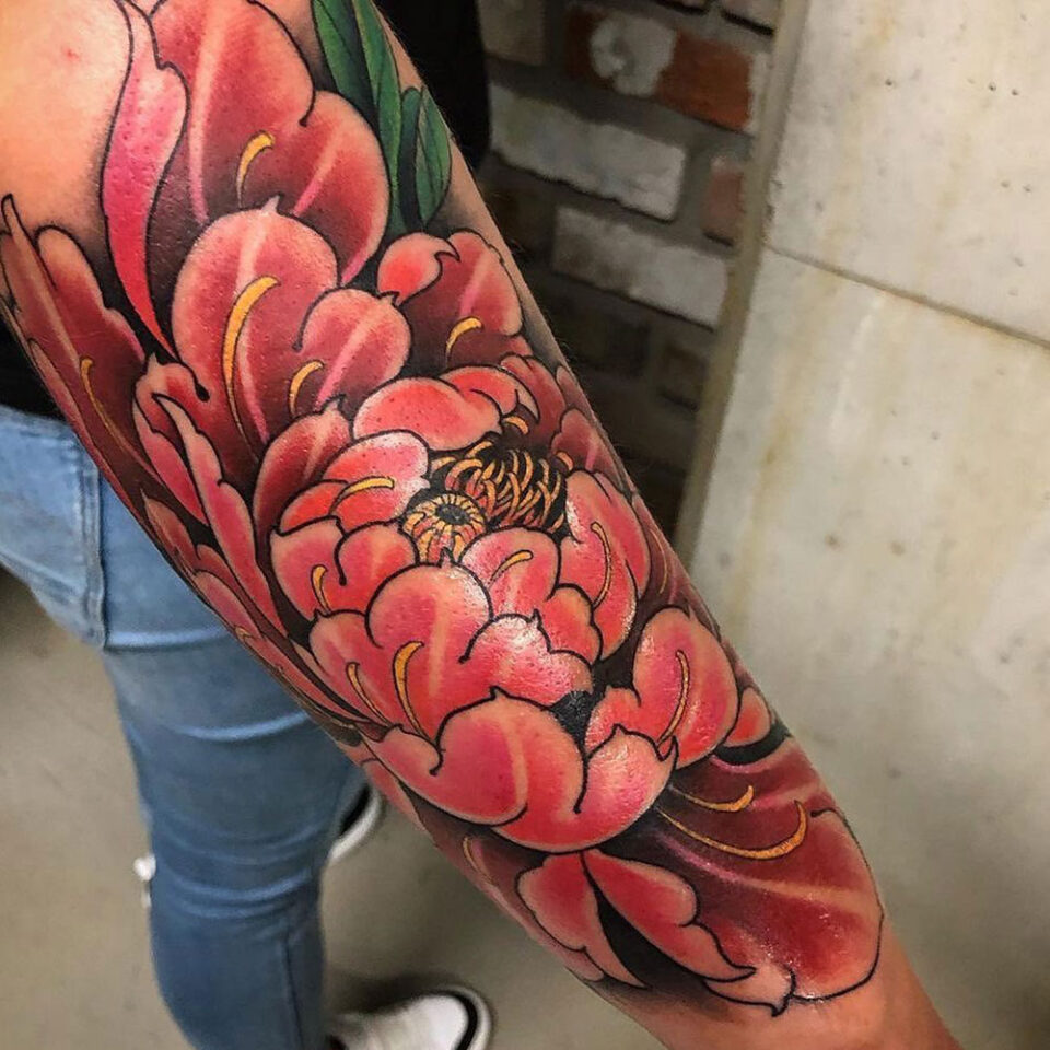 Camellia flower tattoo on the wrist