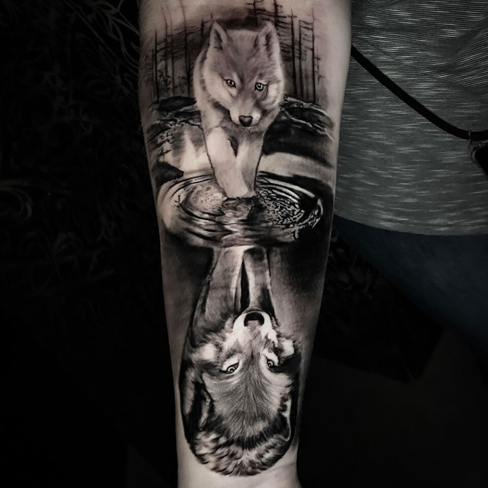 Tattoo uploaded by Ciera  Black  White Wolf Pup Adult Wolf Reflection In  Lake Arm Tattoo BlackandWhite Wolf Arm  Tattoodo