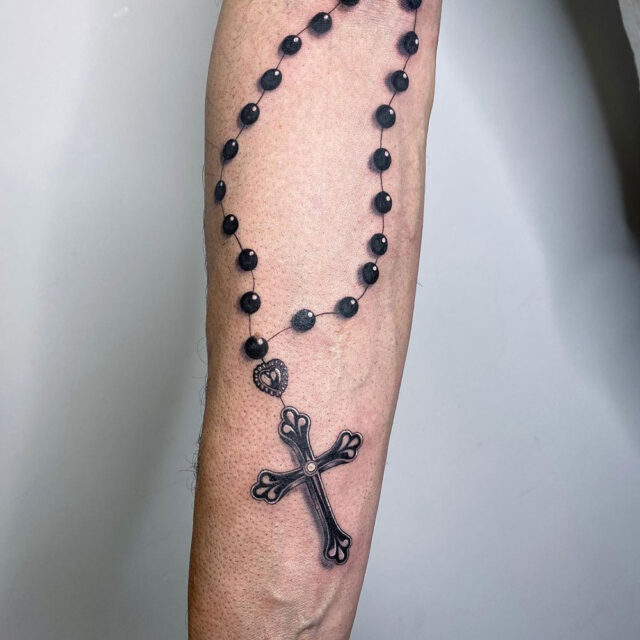 Tattoo uploaded by Tattoodo  Rosary tattoo by Tommy Montoya TommyMontoya  blackandgrey rosary cross realism Jesus beads pearls  Tattoodo