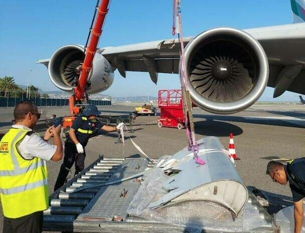 A380 engine part damaged; crane assists.