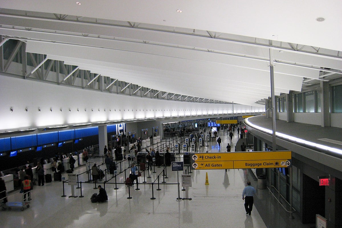 Modern airport terminal with high ceilings, helpful staff.