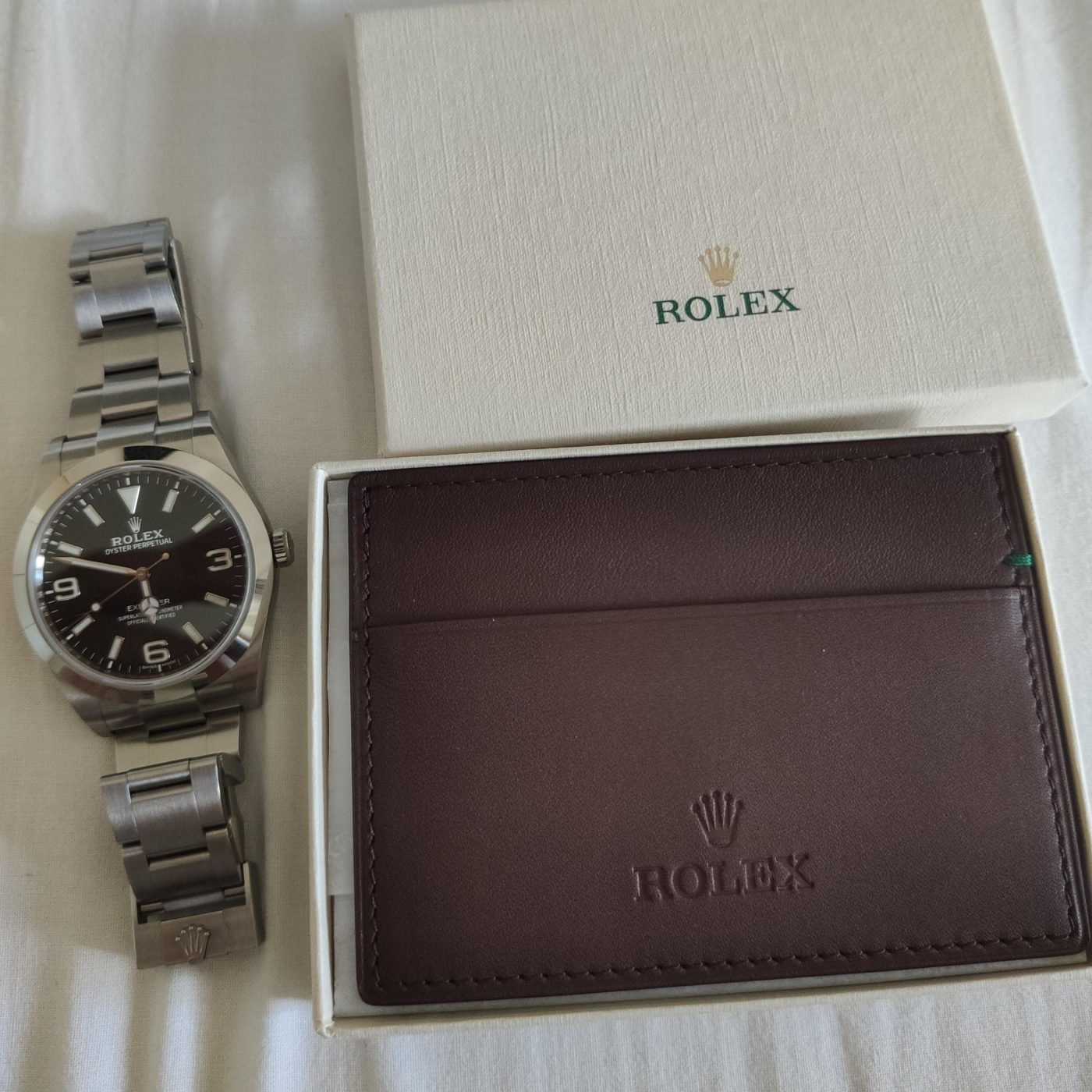 Rolex cuff links, leather wallets, and card holders