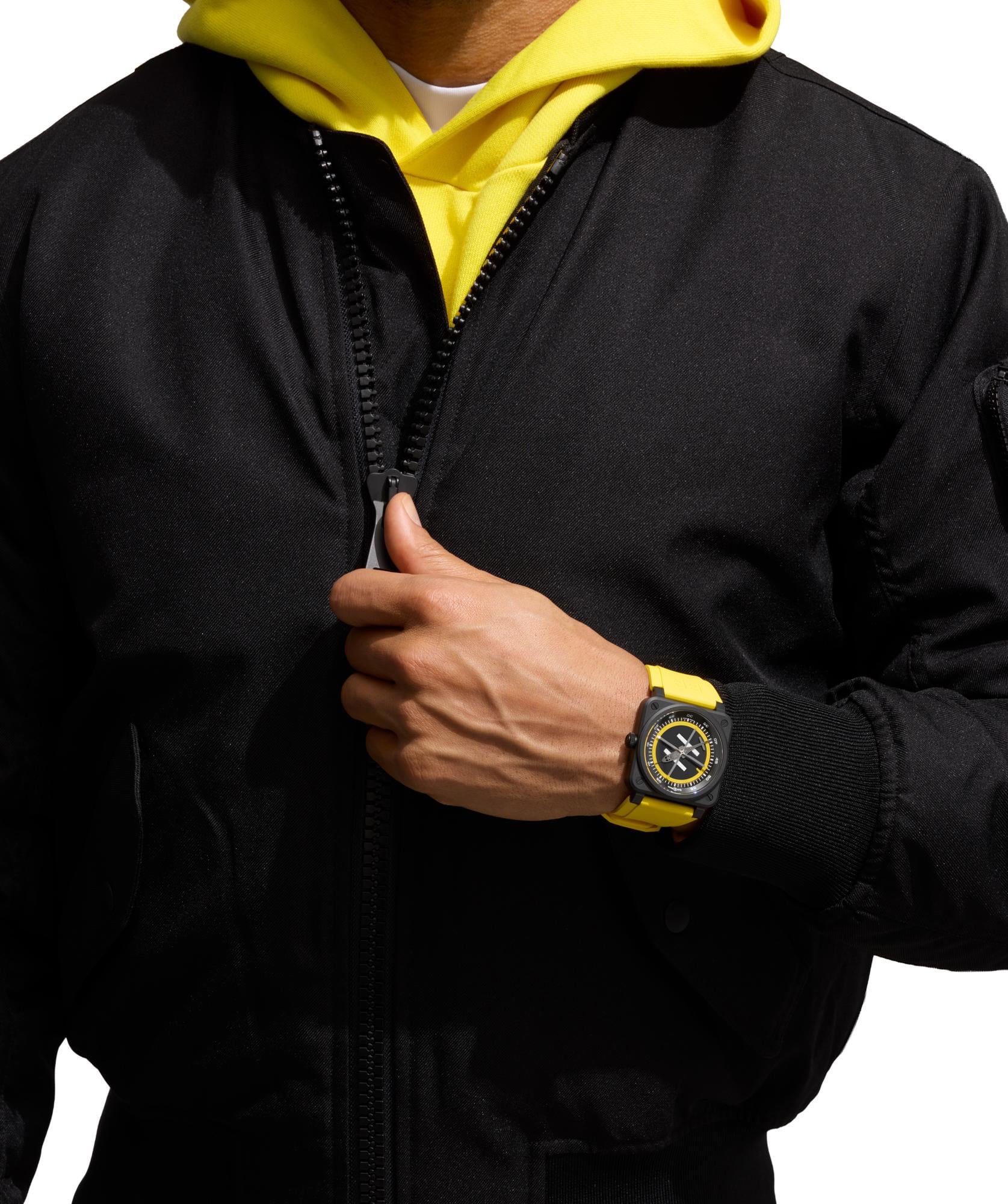 Bell & Ross BR-03 Helipad worn on the black synthetic fabric strap with a flight suit and aviation headset