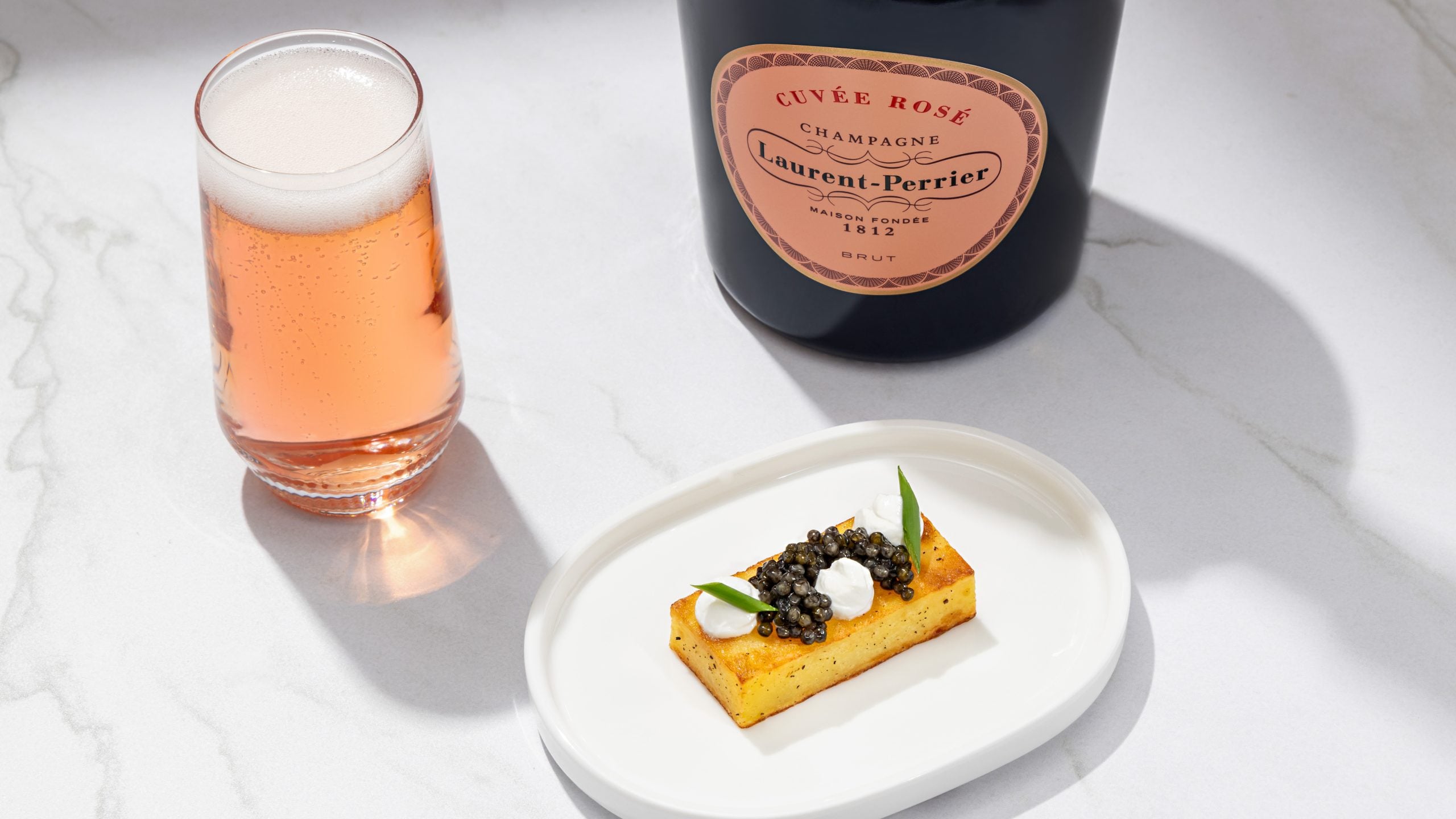 Ossetra caviar amuse-bouche paired with Laurent-Perrier Cuvee Rose in United Polaris Studio